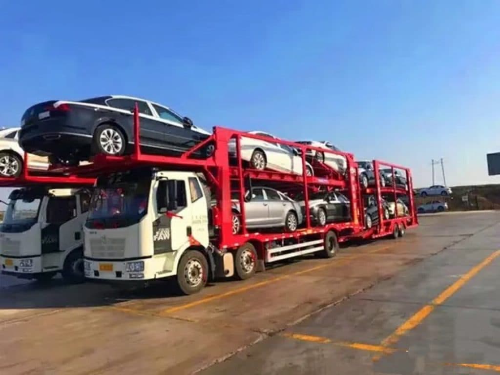 Car-carrier trucks delivering new vehicles to port